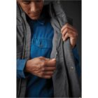 Person in a blue shirt showing the inside pocket of a gray jacket.