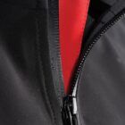 Close-up of a black zipper on black fabric, with a red layer underneath.