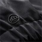 Close-up of a black textured fabric with an embossed circular logo.