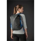 Person wearing a black backpack with blue straps, seen from the back.