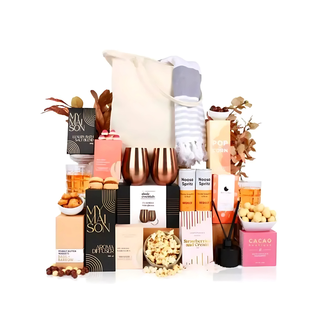YuleFest Holiday Spritz Gift Sets with snacks, drinks, and foliage in a festive tote.