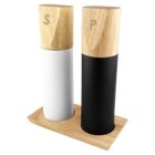 Modern salt and pepper shakers with wooden tops on a wooden tray.