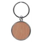A round keychain with a plain wooden center and a metal rim is attached to a metal keyring. The wood has a light, natural finish.