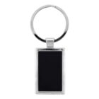 A rectangular keychain with a black insert and silver border is shown. It is attached to a circular silver keyring. The background is plain white.
