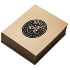 A stack of brown cardboard coasters, bound together like a book with a black circular logo on the cover reading ARCLIGHT with the words IMAGINE DESIGN DESTROY and a stylized A emblem in the center.