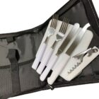 A black zippered case containing a set of white-handled utensils: two knives, two forks, one spoon, and a corkscrew. The case has compartments to hold each item securely.