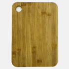 A rectangular bamboo cutting board with a rounded hole in the top left corner. The surface has a natural wood grain pattern.