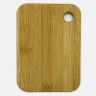 A rectangular wooden cutting board with rounded edges. There is a circular hole near one corner for easy handling or hanging. The surface is smooth, showcasing a natural wood grain pattern.