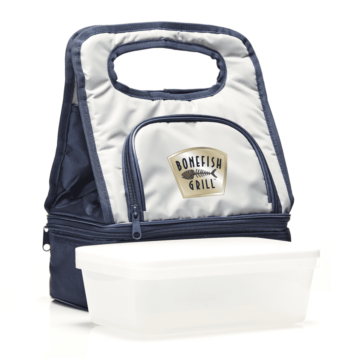 A lunch bag with a soft handle, featuring the Bonefish Grill logo, is displayed with a white rectangular container in front. The bag is primarily gray and black with a zippered pocket.
