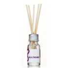 A small glass bottle with a silver cap, labeled HEALTHCARE, containing clear liquid. Several natural reed sticks are inserted into the bottle, likely intended as a diffuser.