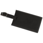 Black leather luggage tag with white stitching and an attached buckle strap. The tag is positioned diagonally on a white background.