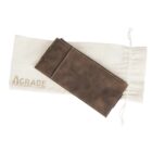 A brown leather wallet displayed on top of a white drawstring bag with the text AGRADE on it. The wallet has visible stitching along its edges.