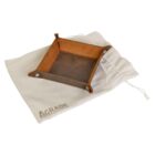 A brown leather valet tray with buttoned corners, placed on a beige drawstring pouch with the AGRADE logo.