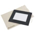 A black rectangular photo frame with a plain white center lies on top of a beige drawstring cloth bag labeled A GRADE.
