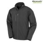 Black softshell jacket with a high collar, zippered front closure, and side pocket. The jacket features a chest pocket with a vertical zipper and is labeled as Result Genuine Recycled in the corner.