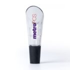 A transparent bottle stopper with a black base is shown. The stopper is branded with the text metroPCS in purple and red lettering on the clear portion.