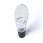 A transparent wine aerator with a black base, viewed from an angle. The acrylic aerator has a round opening at the top and shows multiple small, clear beads inside. The background is plain white.
