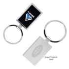 Two rectangular metal keychains with circular rings. The first has a black insert featuring the F-Secure logo. The second shows a plain surface with Land Rover engraved on the back. Both have a sleek, modern design.