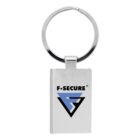 A silver metal keychain with a rectangular tag featuring the F-Secure logo in blue and black. The logo includes a stylized letter F and the text F-SECURE above it.