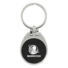 A silver keychain with an oval-shaped medallion featuring a black center. In the center, there is a white logo of concentric circles and the text MARRATECH beneath it. The keychain has a smooth metallic finish.