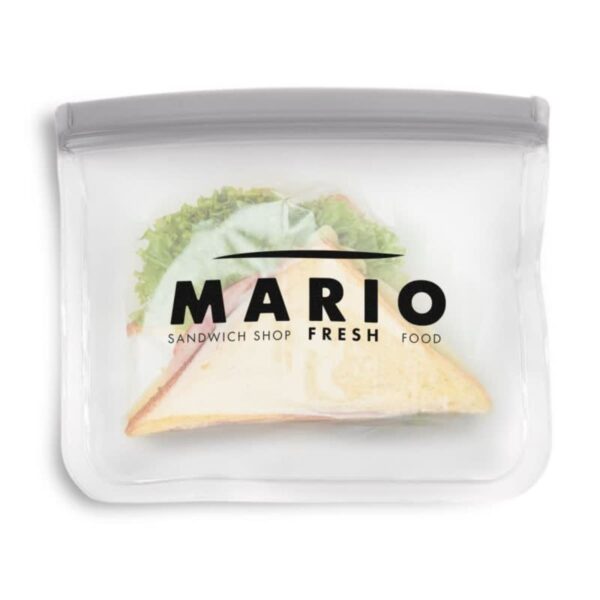 A sandwich with lettuce and meat is partially visible inside a transparent, reusable bag. The bag has the text MARIO SANDWICH SHOP FRESH FOOD printed on it in bold black letters.