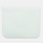 A transparent, rectangular, reusable silicone storage bag with a zip-lock closure at the top. The bag has a flat base, allowing it to stand upright.