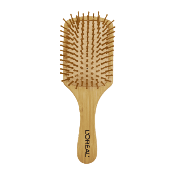 Wooden paddle hairbrush with a wide, flat base featuring spaced bristles. The handle has LOreal printed on it. The brush is designed for smoothing and detangling hair.