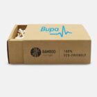 A box of bamboo cotton buds is partially opened, revealing some buds inside. The box displays the text Bamboo range and 100% Eco-Friendly in black, along with a blue logo and the word Bupa on the lid.