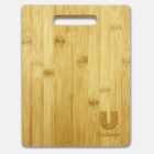 A rectangular bamboo cutting board with a handle cutout at the top. The board features a decorative U logo with intricate patterns on the bottom right corner, along with the word Unilever written beneath it.