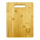 A rectangular bamboo cutting board featuring an engraved logo in the bottom right corner. It has a cut-out handle near the top. The wood grain is visible and creates a natural pattern.