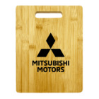 A wooden board featuring the Mitsubishi Motors logo in black, with the brand name written below it. The wood has a natural grain pattern and a rectangular cutout at the top for easy handling.