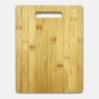 A rectangular bamboo cutting board with a handle cutout at the top sits against a white background. The wood has a natural grain pattern, giving it a smooth and polished appearance.