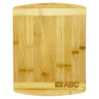 A rectangular bamboo cutting board with a light wood grain pattern, featuring a small logo with interlocking letters at the bottom right corner.