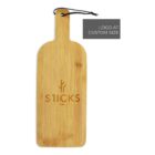 A rectangular wooden cutting board with a handle at the top, featuring the word STICKS and a decorative symbol engraved. A black string loops through the handle. A gray label on the side reads, LOGO AT CUSTOM SIZE.