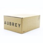 A cardboard box with AUBREY printed in large letters on the side. The box is plain with a minimalist design, and there is a line drawing of a cup on the side. The capacity is indicated as 180 mL.