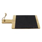 A rectangular wooden cutting board with a handle on the left side and a black slate surface covering most of the board. A rope loop is tied through a hole in the handle.