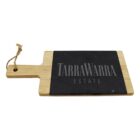 A rectangular wooden cheeseboard with a handle, featuring a black slate section. The slate is engraved with the text TARRAWARRA ESTATE in capital letters. A looped rope is attached to the end of the handle.