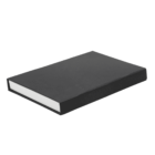 A closed black rectangular book, viewed from an angle, is lying on a white background. The book’s spine is not visible, and the focus is on the books plain cover.