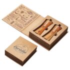 Open cardboard gift box displaying two wooden salt and pepper shakers. The lid features text and illustrations about cheese and spices, with Republic of Carnivia printed on it. The box has a rustic, elegant design.