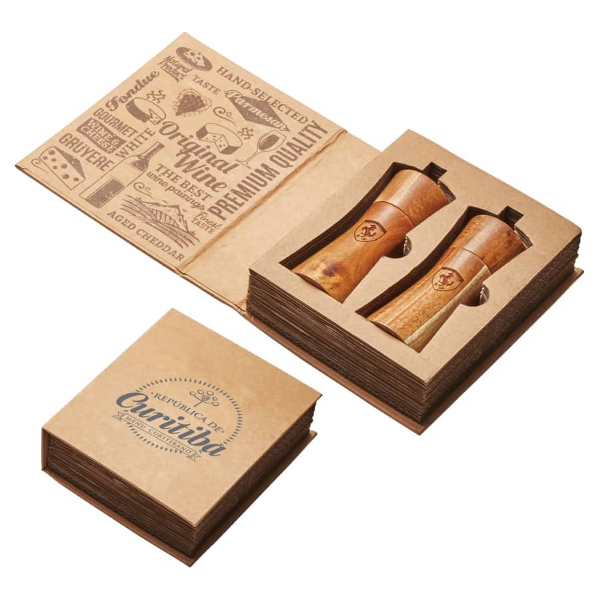 Open cardboard gift box displaying two wooden salt and pepper shakers. The lid features text and illustrations about cheese and spices, with Republic of Carnivia printed on it. The box has a rustic, elegant design.
