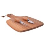 A wooden cutting board with a small cheese knife and a fork, both with wooden handles, placed on top. The board has a handle with a looped string for hanging.