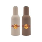 Two bottle-shaped salt and pepper grinders featuring the Hard Rock Cafe logo. The left grinder is light beige, and the right one is brown. They have a cylindrical design with a metal top.
