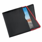 A black folder with a red trim partially open, showing a glossy brochure with a colorful cover displaying a photograph of a desert landscape with blue sky, sand, and distant mountains.