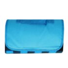 A folded blue picnic blanket with a handle on top sits against a plain white background.