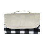 A folded picnic blanket with a black and white checkered pattern. It has a beige fabric cover and a handle on top for easy carrying.