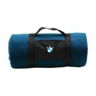 A rolled-up blue blanket with a black strap and handle. The BMW logo is prominently displayed on the black strap in the center.