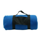 A rolled-up blue fleece blanket with black straps and a handle, designed for easy carrying. The straps wrap around the blanket, and there is a rectangular black panel in the center.