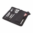 A set of stainless steel barbecue tools in a black zippered carrying case. The set includes a fork, tongs, and a spatula, all with metal handles, neatly organized in the case. A red and white booklet is also visible inside.