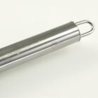 A stainless steel rolling pin with a handle loop on one end is placed against a plain light background. The rolling pin has a shiny, smooth surface.