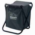 A black folding stool with a built-in storage bag. The bag features the text Brands Construction alongside a graphic of stylized buildings. The frame is metal, providing support for the seat and carrying handle.